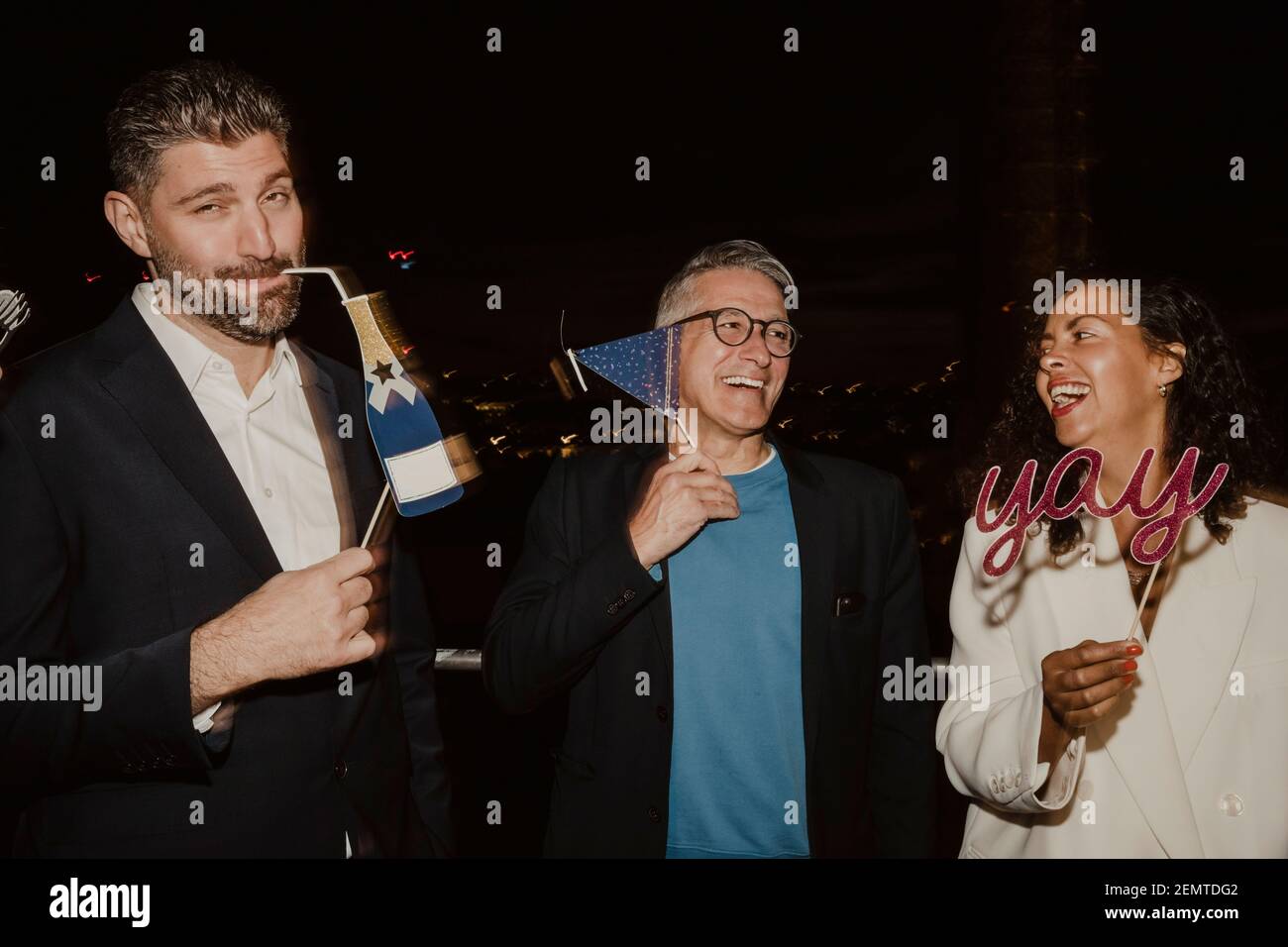 Happy business people with props during part at night in office Stock ...