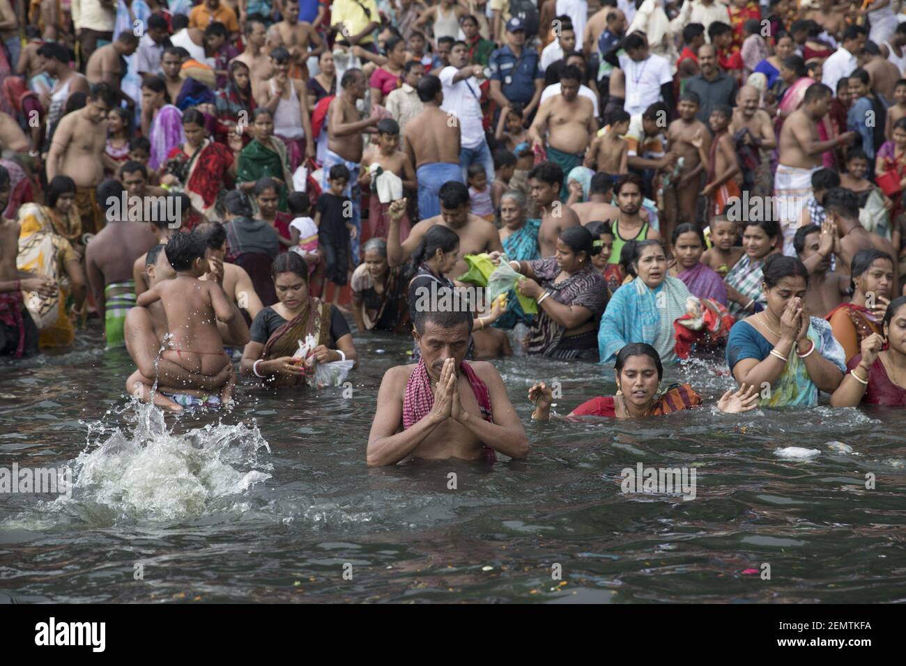Bangladeshi Hindu devotees take a holy bath and pray in the Brahmputra ...