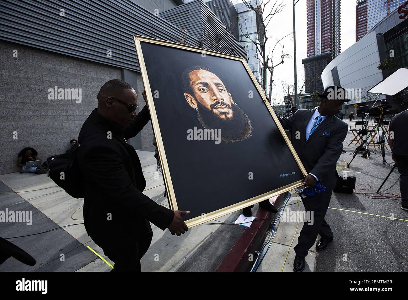 A painting of Nipsey Hussle carried in to the Staples Center at the