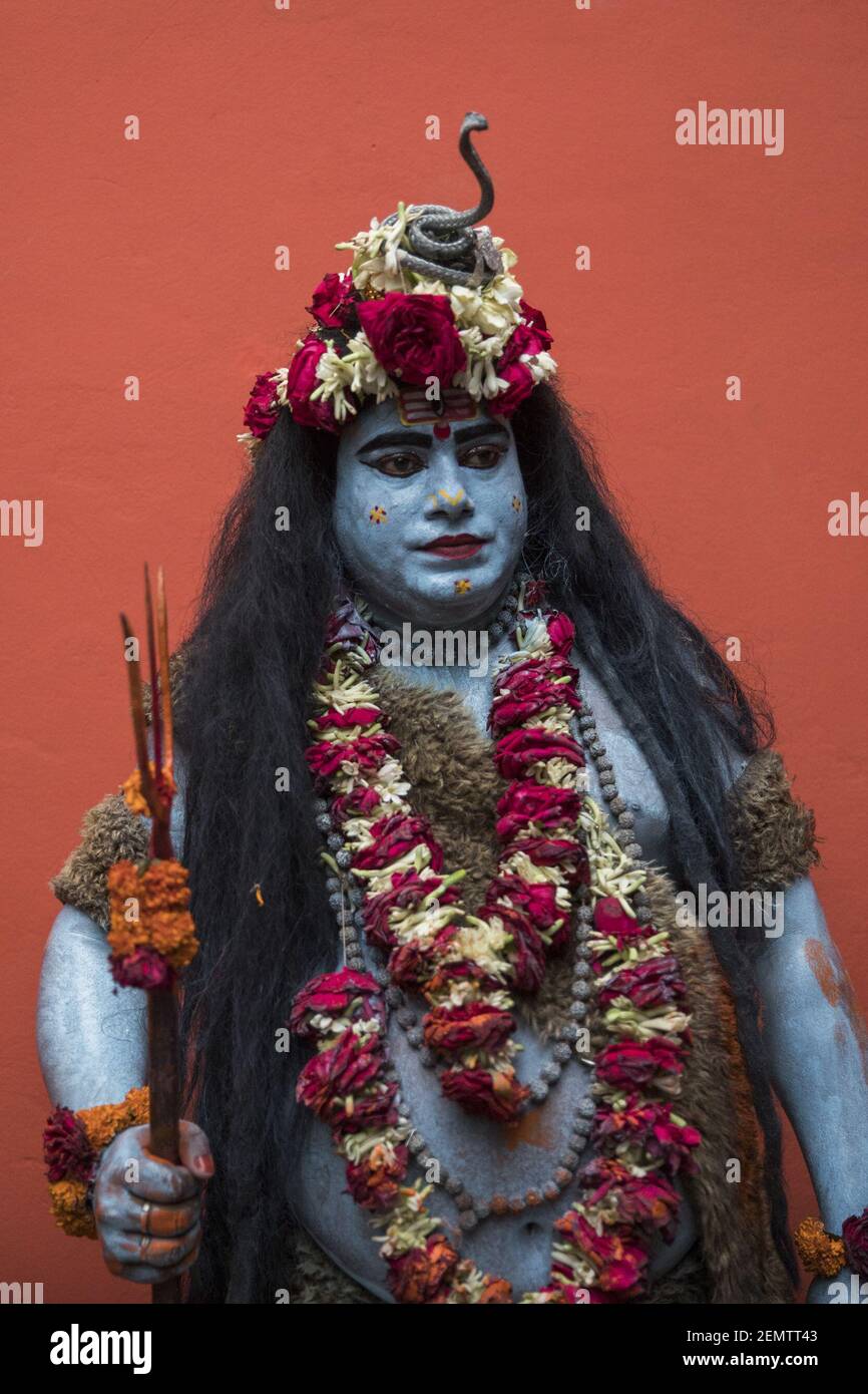A Hindu man dressed as Hindu God Shiva, pose for a portrait as ...