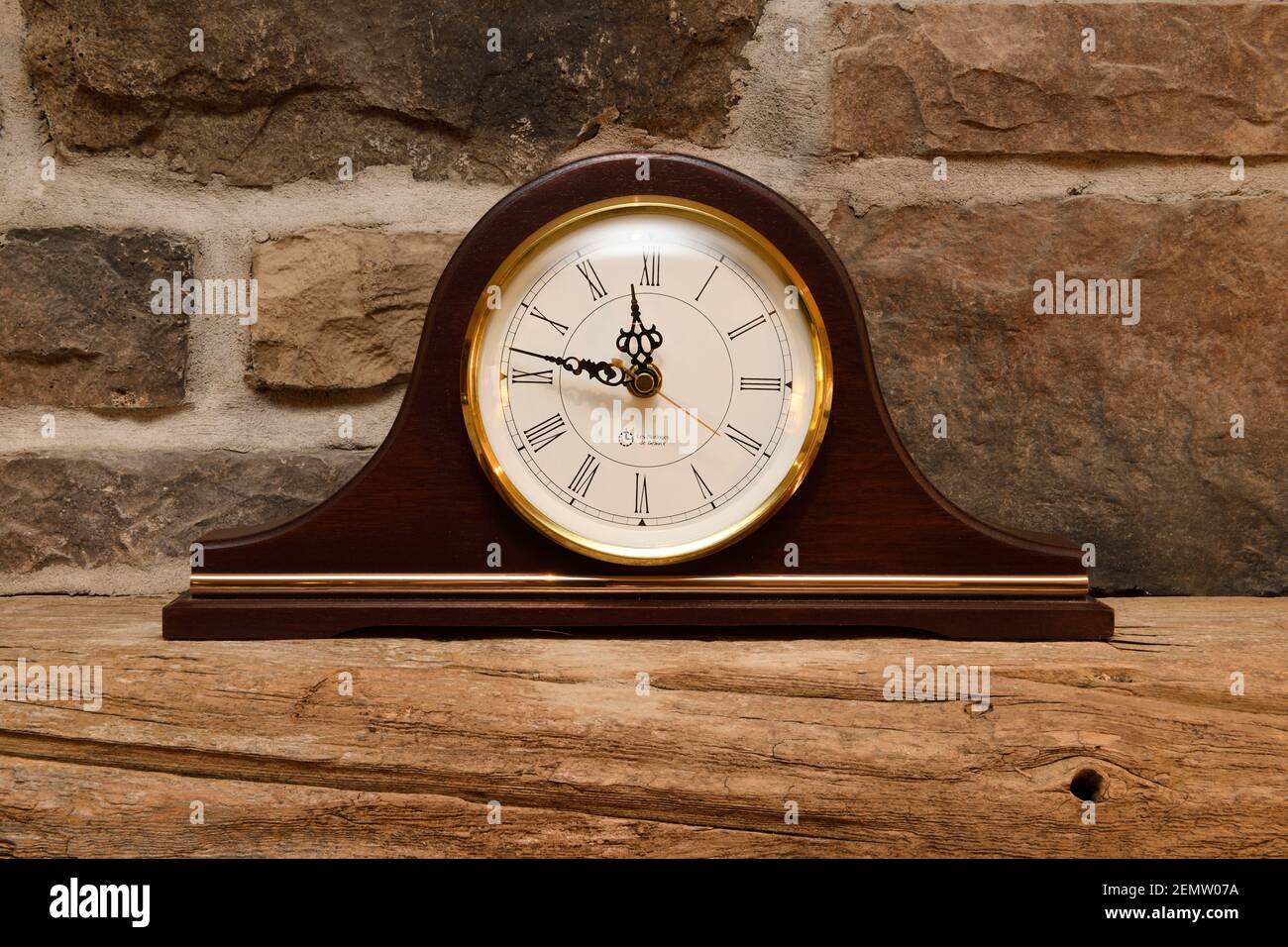 Antique mantelpiece clock on reclaimed barn beam mantle over stone