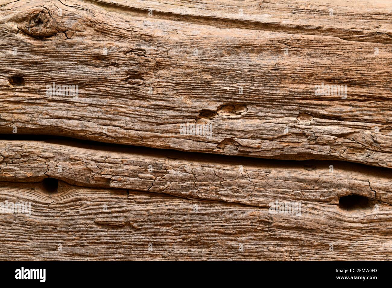 Old weathered pine wood beam from barn used as a fireplace mantel Stock Photo