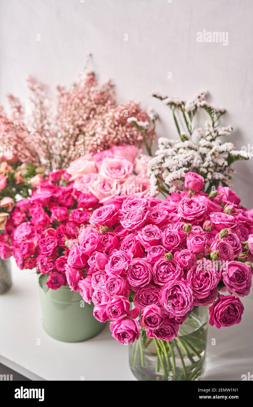 Set of white, pink and magenta flowers for Interior decorations. The work of the florist at a flower shop. Fresh cut flower. Stock Photo