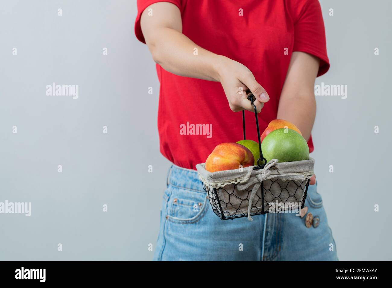 Female model holding a fruit basket Stock Photo - Alamy