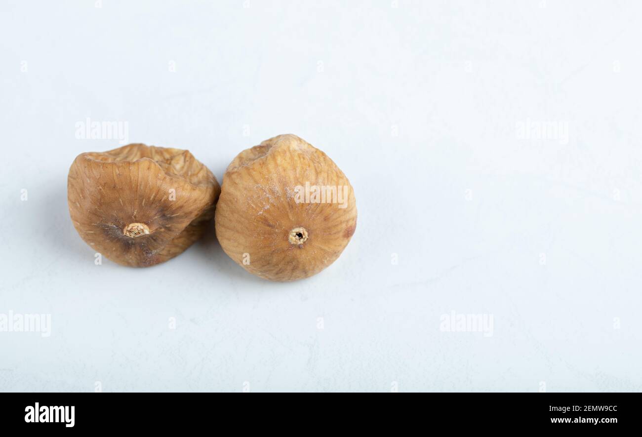 Two dried figs on white background Stock Photo