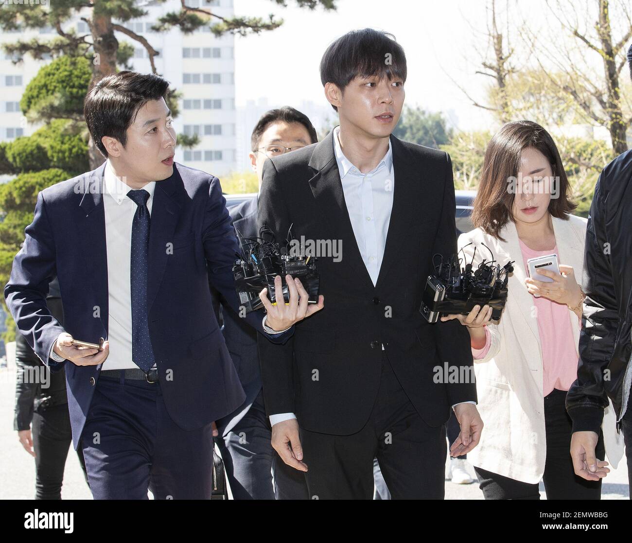 South Korean actor and singer Park Yoo-chun, (stage name: Micky Yoochun),  (center), member of K-Pop boys band JYJ, is surrounded by media upon his  arrival at the South Gyeonggi Provincial Police Agency