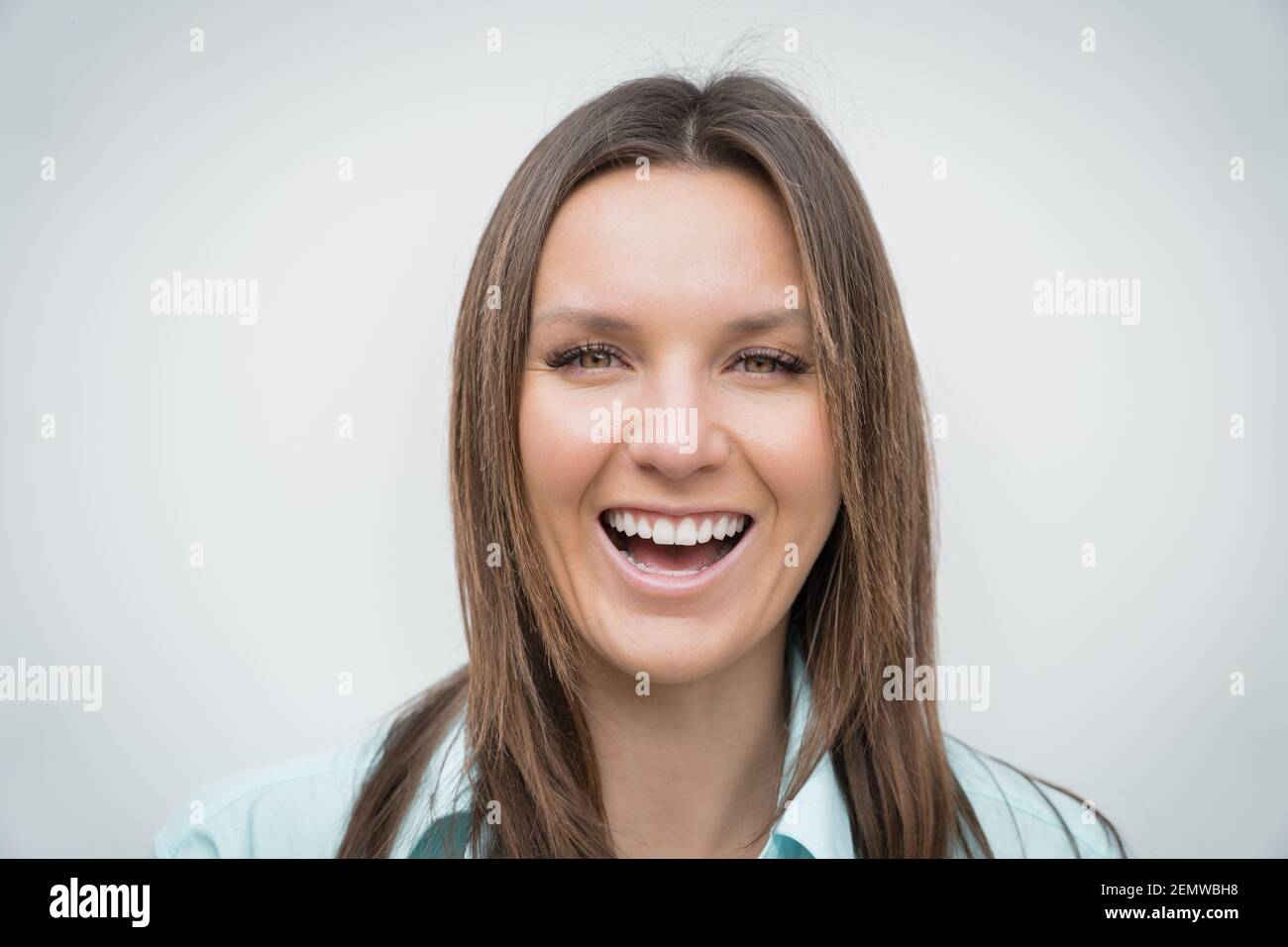 Cheerful happy smiling woman with white perfect smile looking at the camera Stock Photo