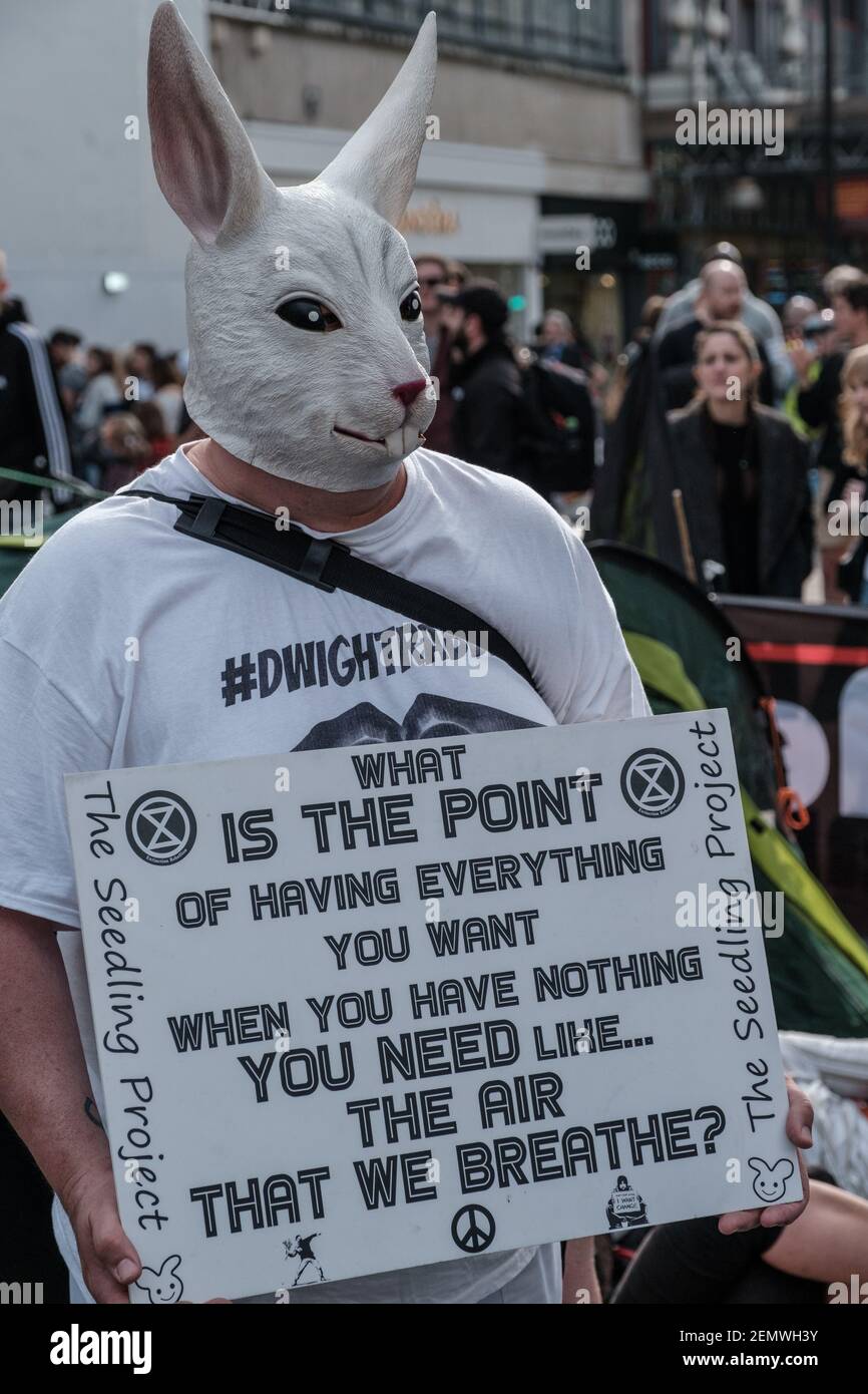 Red Rabbit Protest A man with a rabbit mask holding a placard in Oxford Circus during the ...