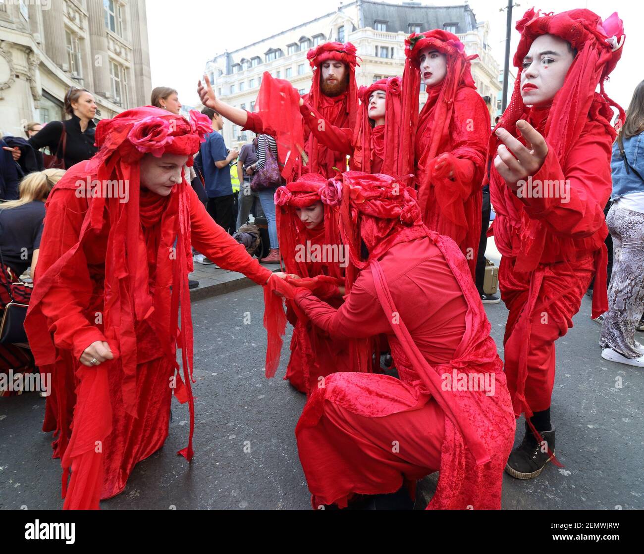 Performers seen in fancy costumes in the crowd during the demonstration