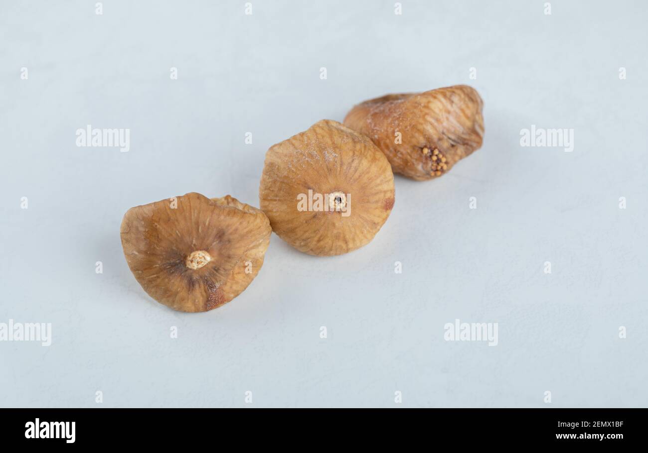 Three dried figs on white background Stock Photo