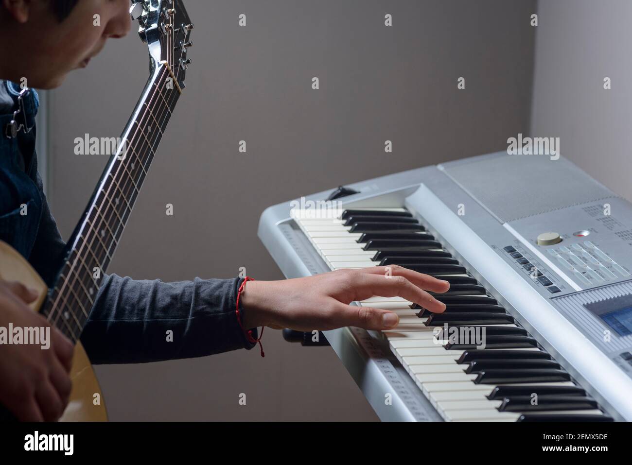 Teenage boy, composing music  in his bedroom ,London,Uk Stock Photo