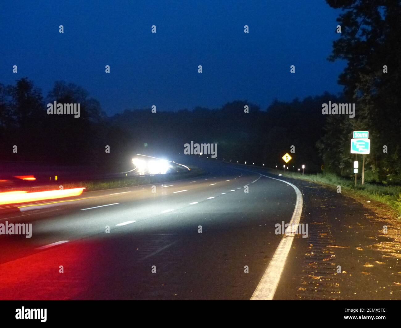 New York State Thruway in the evening showing tail lights and headlights Stock Photo