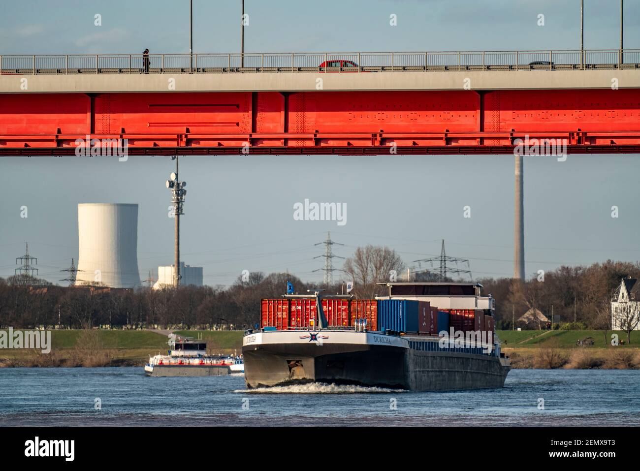 Container cargo ship on the Rhine near Duisburg-Ruhrort, Friedrich-Ebert-Brücke road bridge over the Rhine, cooling tower of the UNIPER coal-fired pow Stock Photo