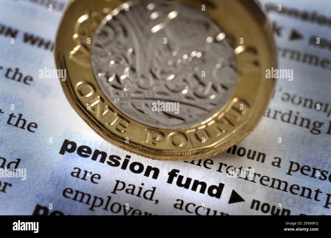 DICTIONARY DEFINITION OF WORD PENSION FUND WITH ONE POUND COIN RE PENSIONS RETIREMENT SAVINGS PENSIONERS ETC UK Stock Photo