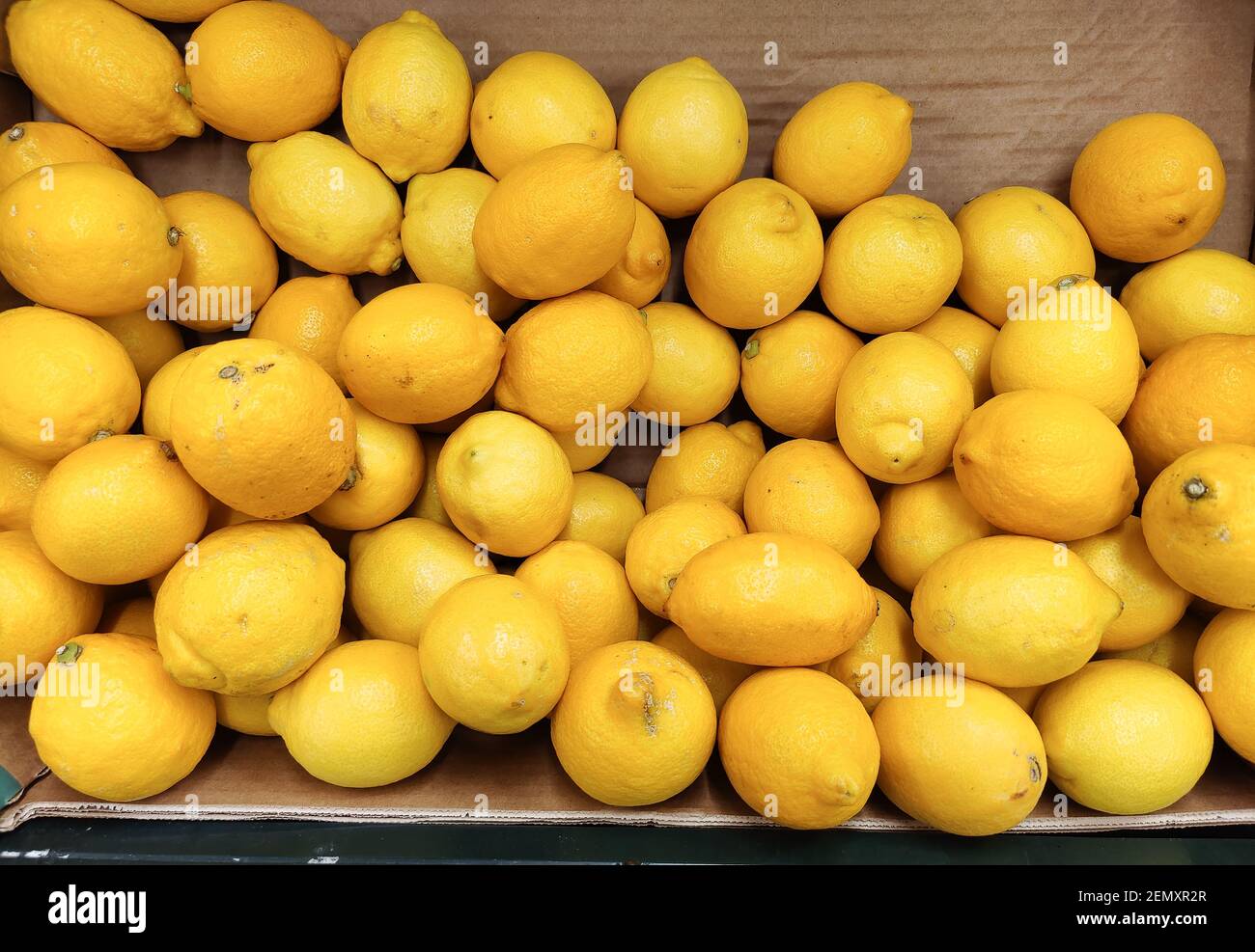 Loose lemons on display in a cardboard box Stock Photo Alamy
