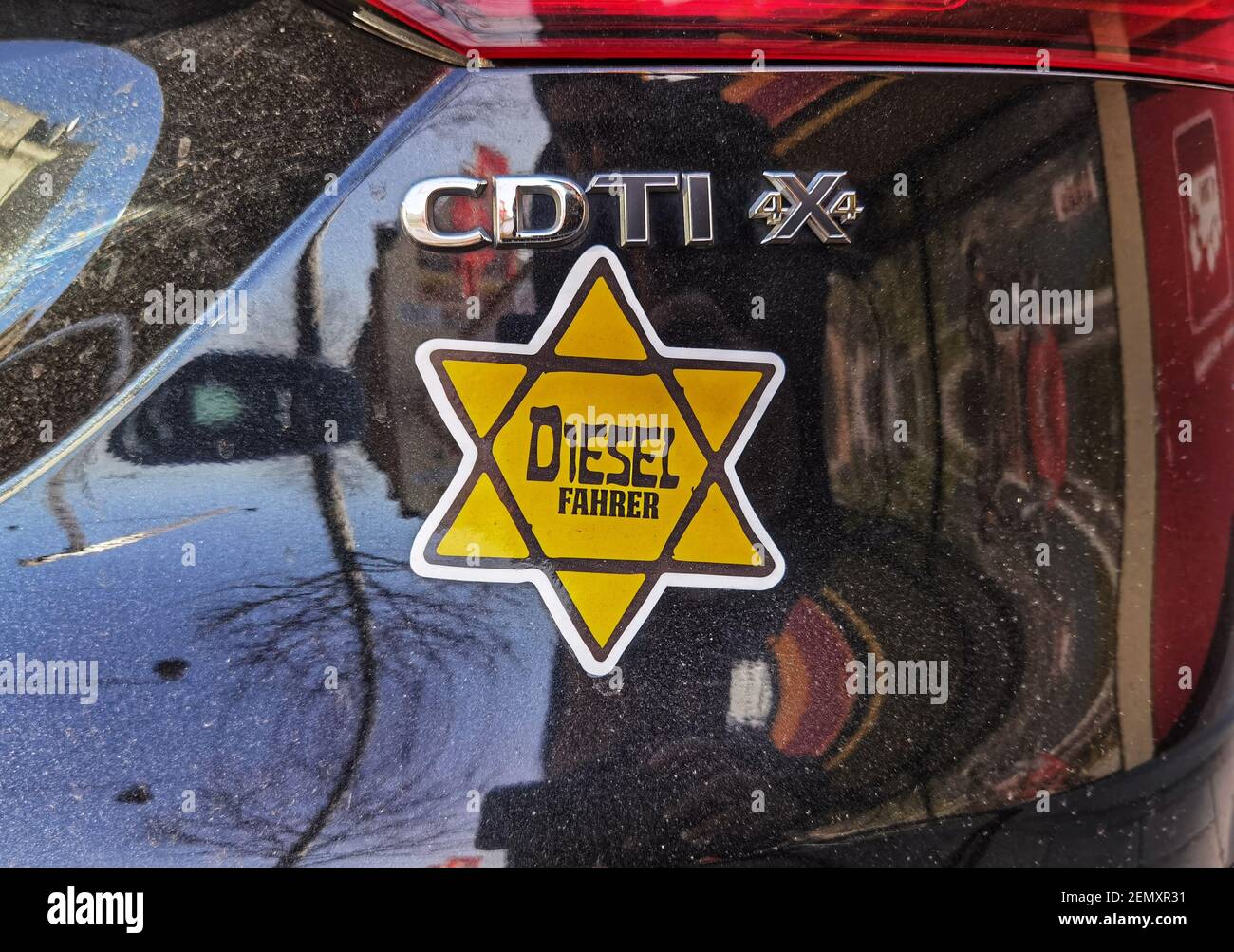 Munich, Bavaria, Germany. 25th Feb, 2021. A 1933-esque Star of David bumper  sticker on a diesel vehicle with Dachau license plates is an example of  antisemitism and trivialization of the Holocaust seen