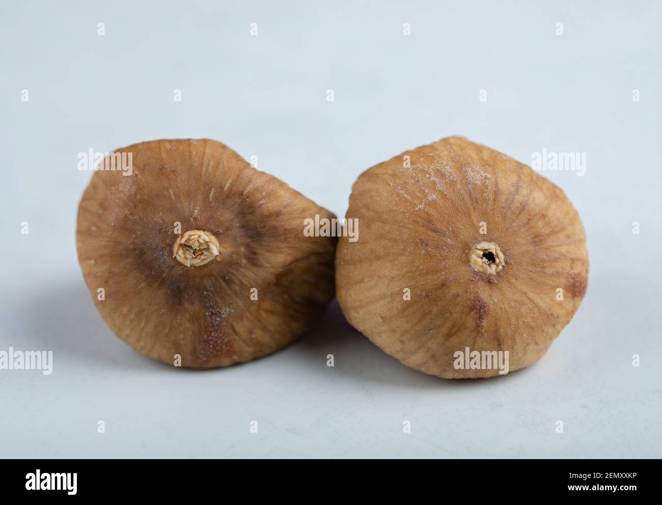 Two dried figs on white background Stock Photo