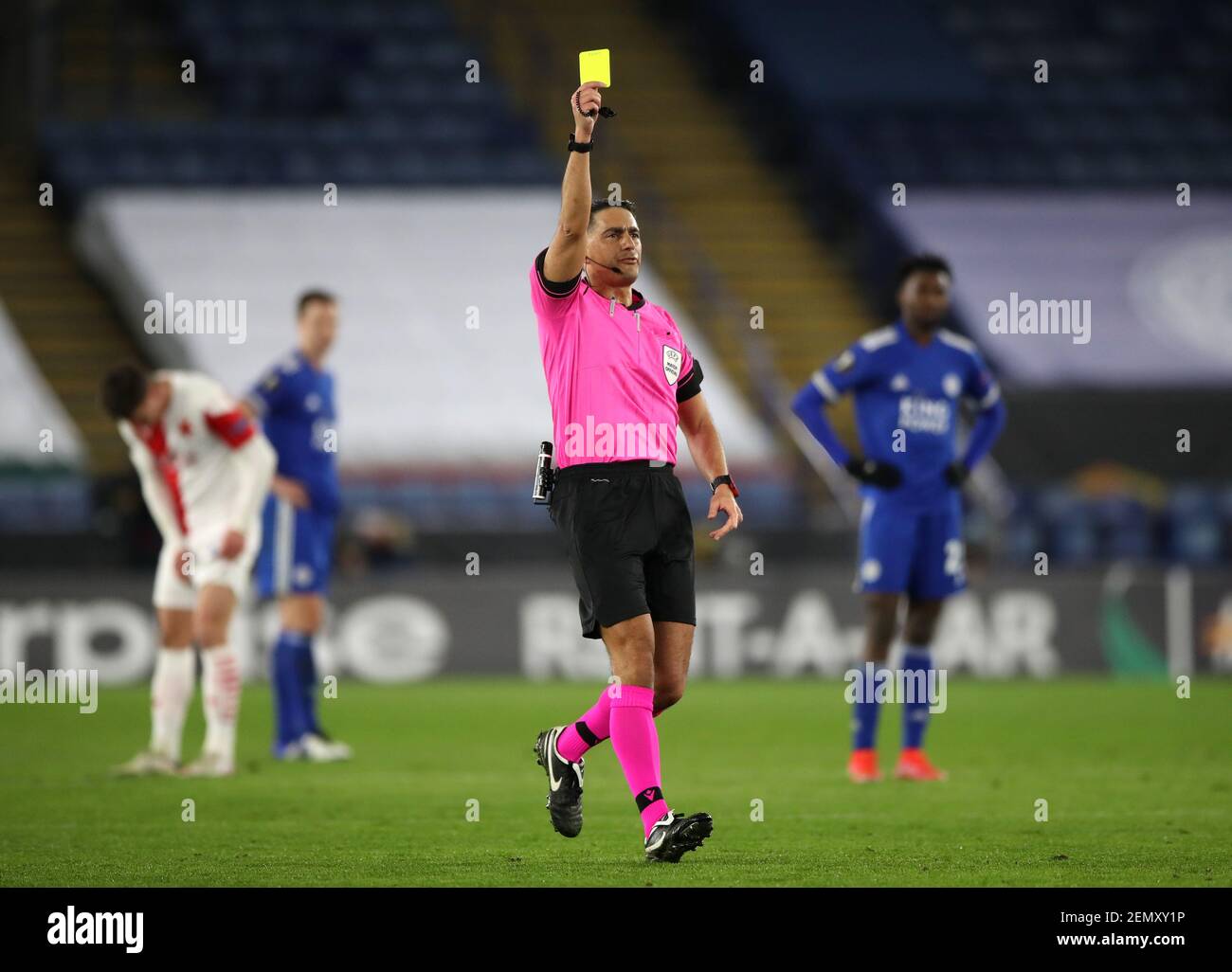 Referee Serdar Gozubuyuk (centre) shows a yellow card to Slavia Praha goalkeeper Ondrej Kolar (not pictured) during the UEFA Europa League match at the King Power Stadium, Leicester. Picture date: Thursday February 25, 2021. Stock Photo