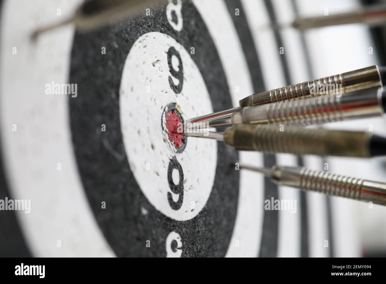 Metal darts sticking out in a dartboard target Stock Photo Alamy