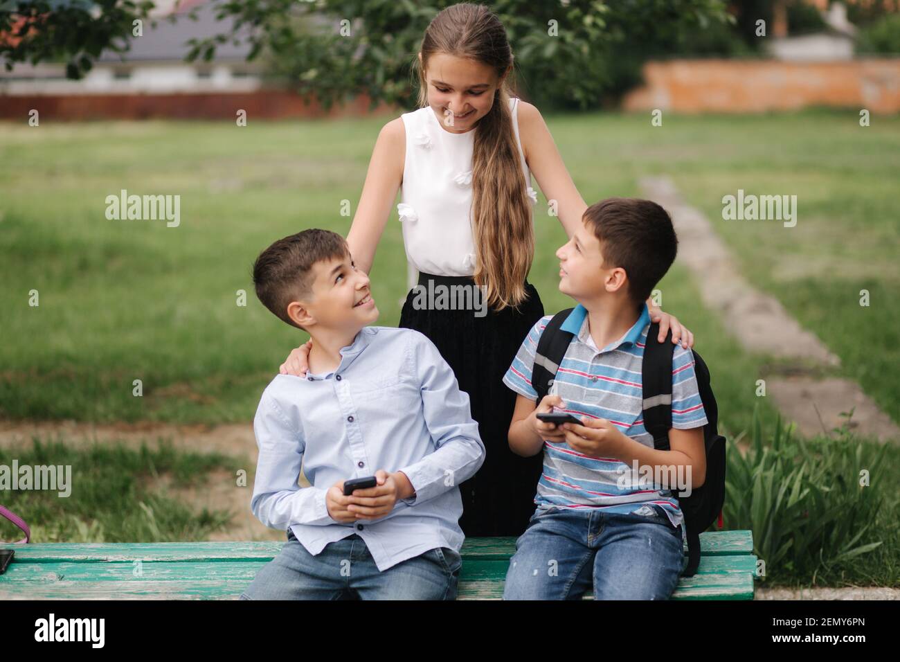 Two boys plays online games in quarantine. Young boys smile and use phone.  One look how play another Stock Photo - Alamy