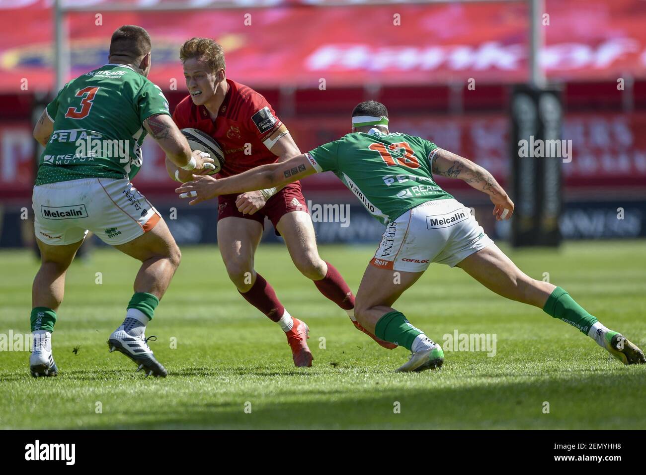 Mike Haley of Munster tackled by Marco Riccioni of Benetton and Marco Zanon  of Benetton during the Guinness PRO14 Quarter-Final match between Munster  Rugby and Benetton Treviso at Thomond Park Stadium in