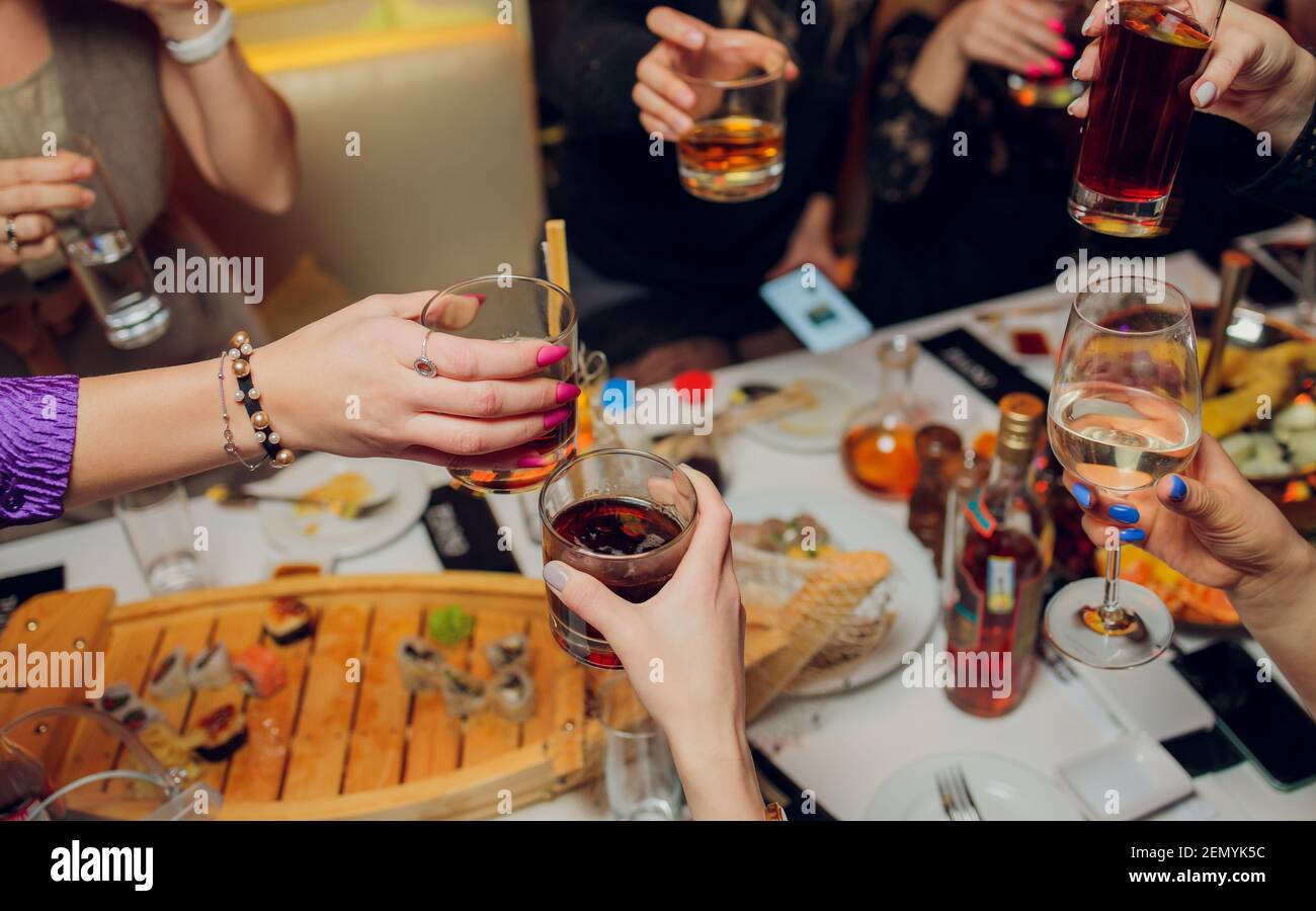 Clinking glasses with alcohol and toasting, party Stock Photo Alamy
