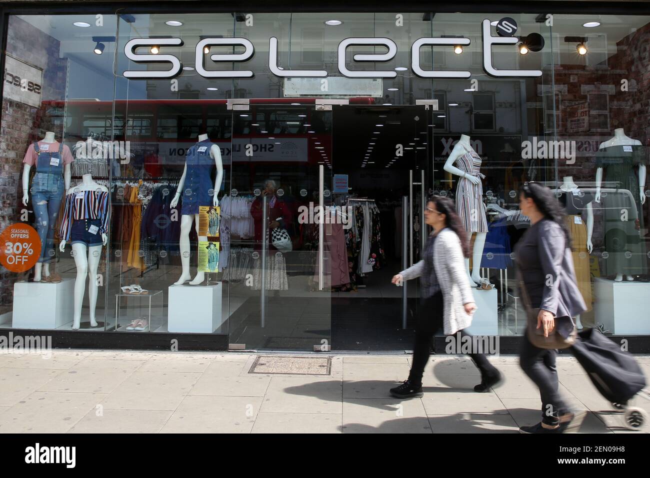 Shoppers are seen walking past Select fashion chain store in north