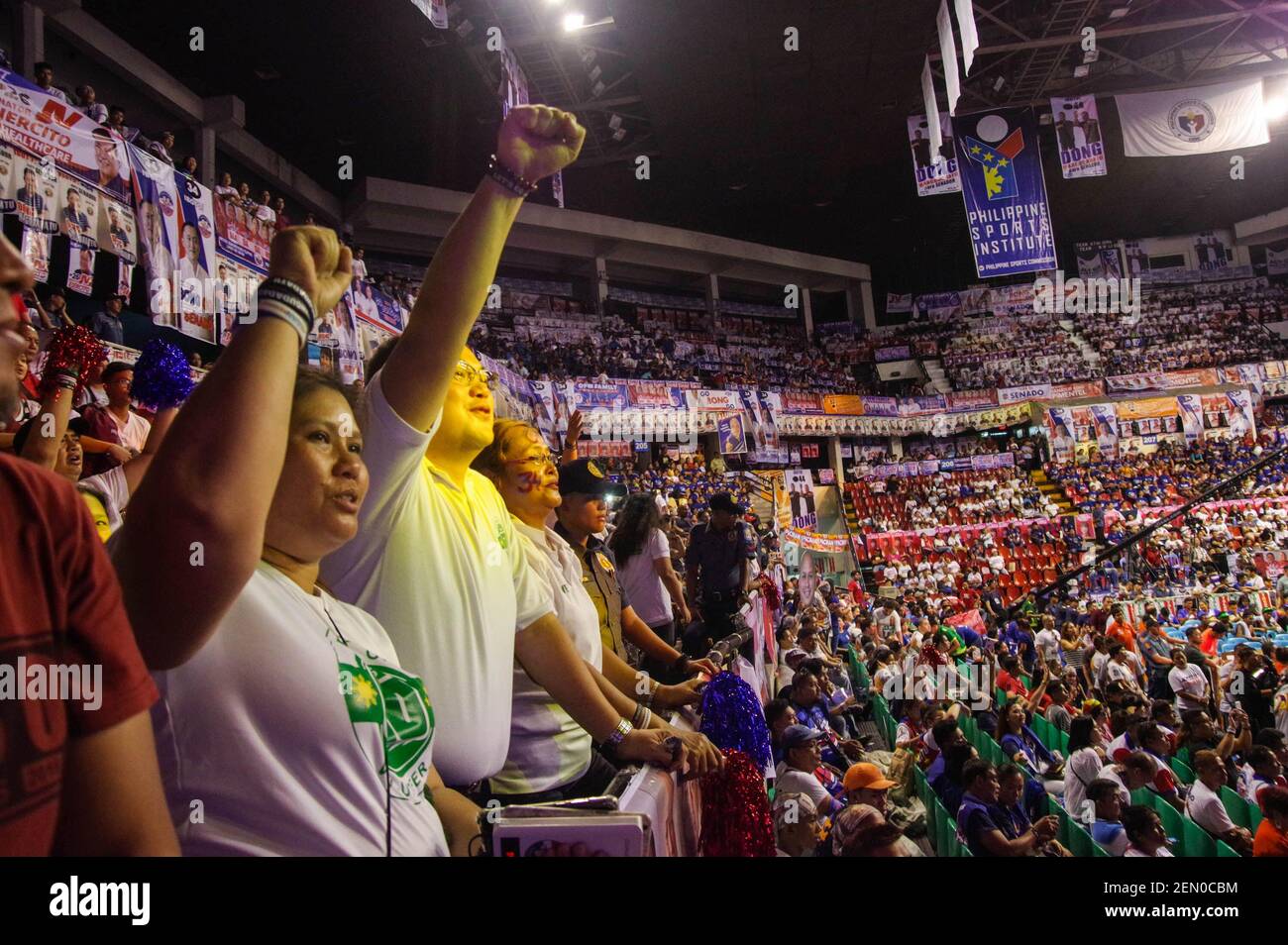 PDP-Laban and Hugpong ng Pagbabago supporters raise fists during PDP-Laban's Campaign Rally at Philsports Complex in Pasig City on Saturday, 11 May 2019.) Stock Photo