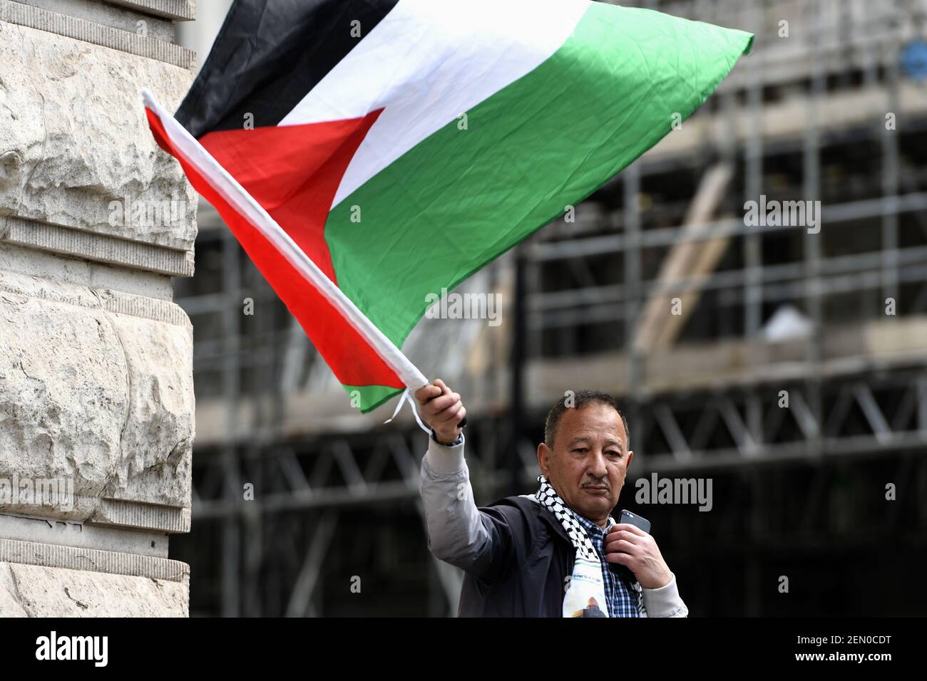 A protester is seen holding a Palestinian flag during the demonstration ...