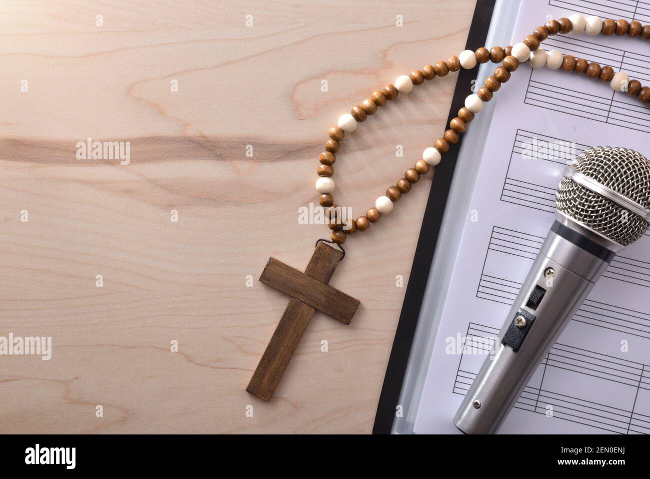 Conceptual detail of Christian religious music with mic on sheet music