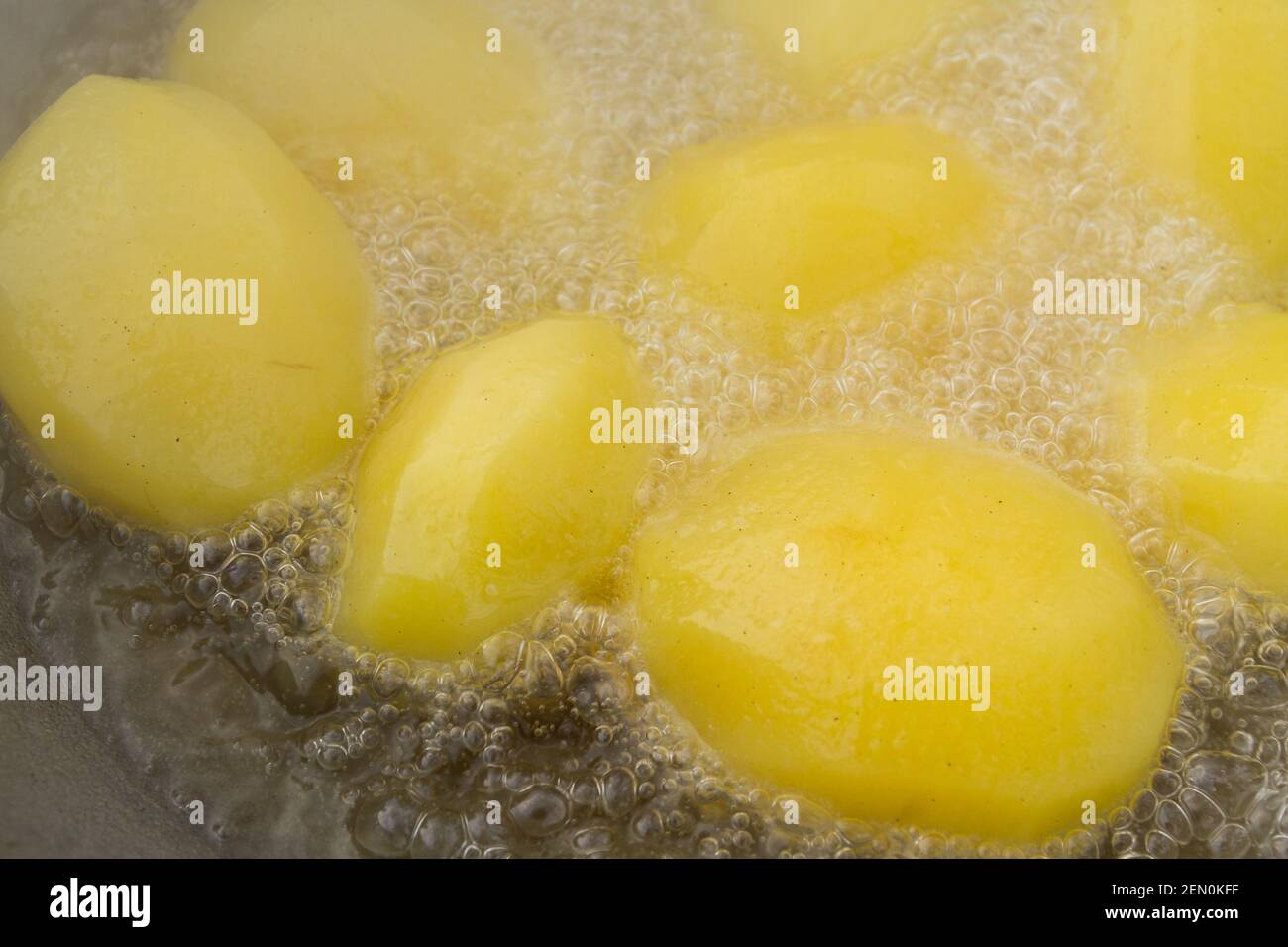 Golden potatoes are fried in boiling oil in a cauldron Stock Photo Alamy