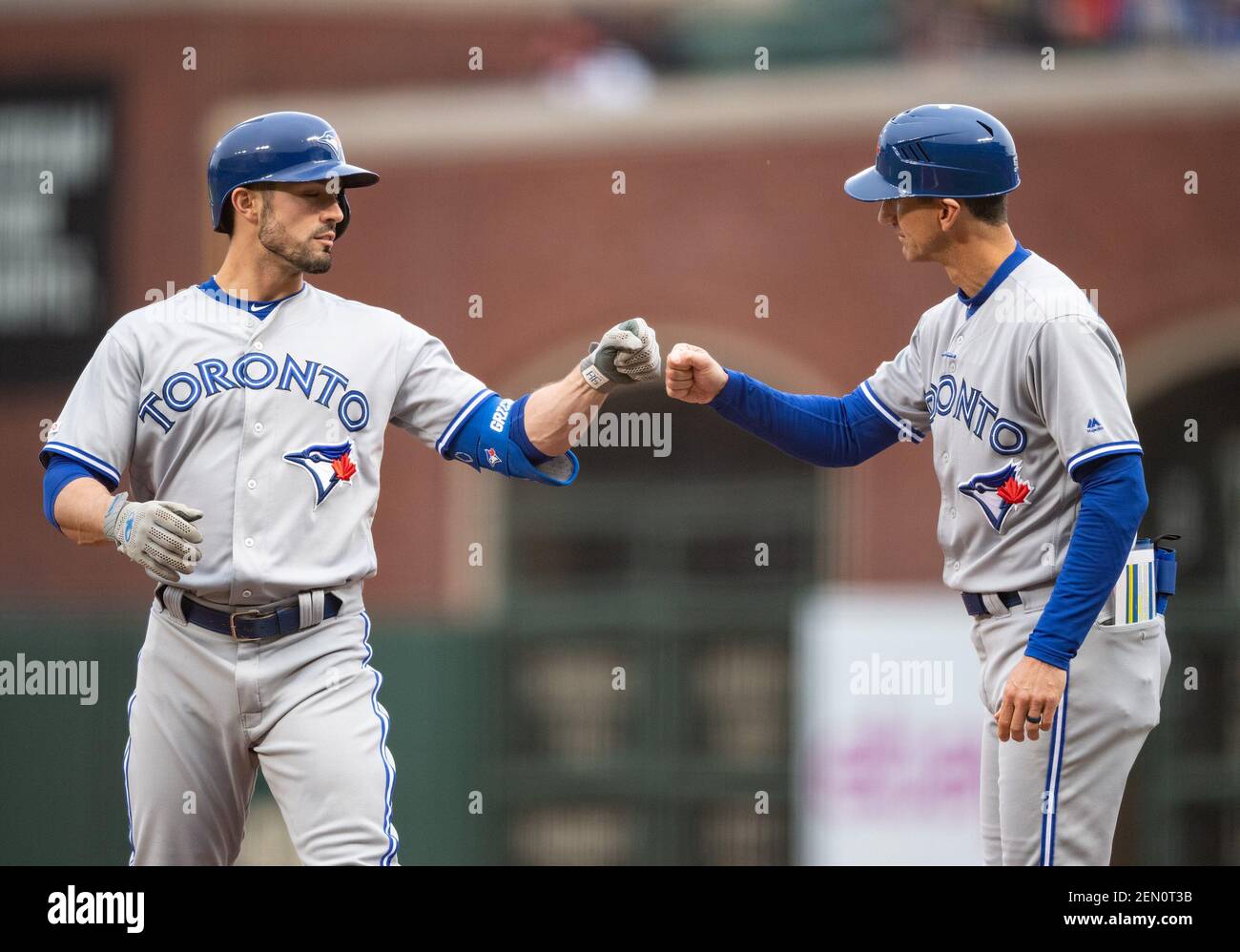 May 14, 2019: Toronto Blue Jays right fielder Randal Grichuk (15) gets a  fist bump for his first inning sinle from first base coach Mark Budzinski  (53), during a MLB game between