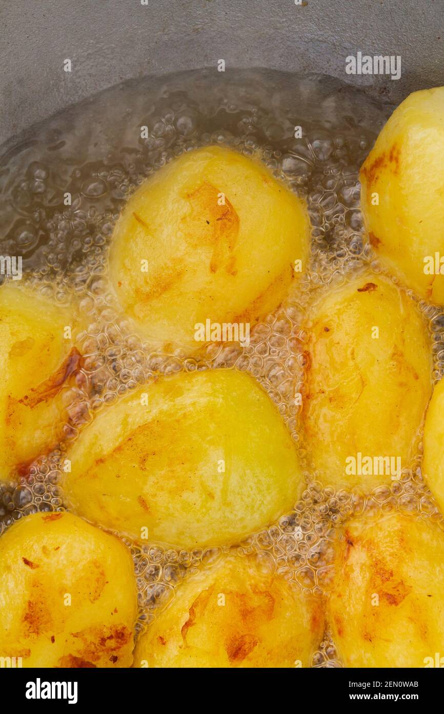 Golden potatoes are fried in boiling oil in a cauldron Stock Photo Alamy