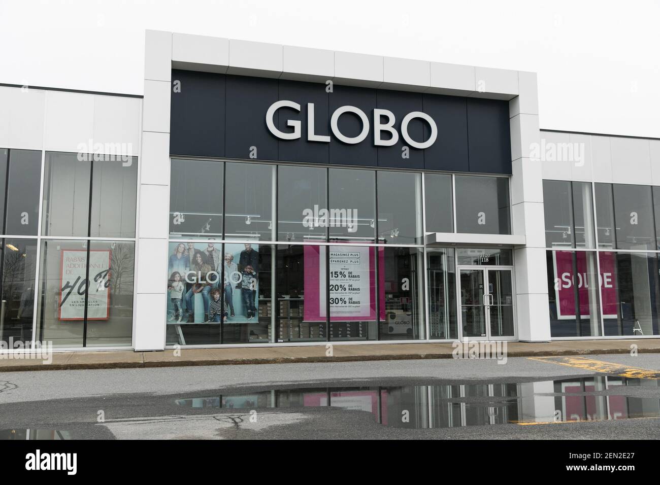 A logo sign outside of a Globo Shoes retail store location in Vaudreuil