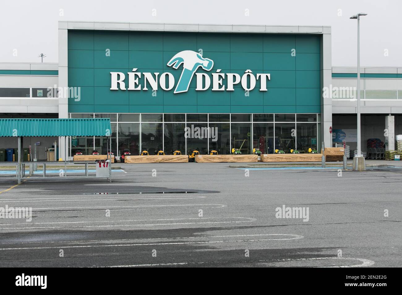 A logo sign outside of a RenoDepot retail store location in Vaudreuil