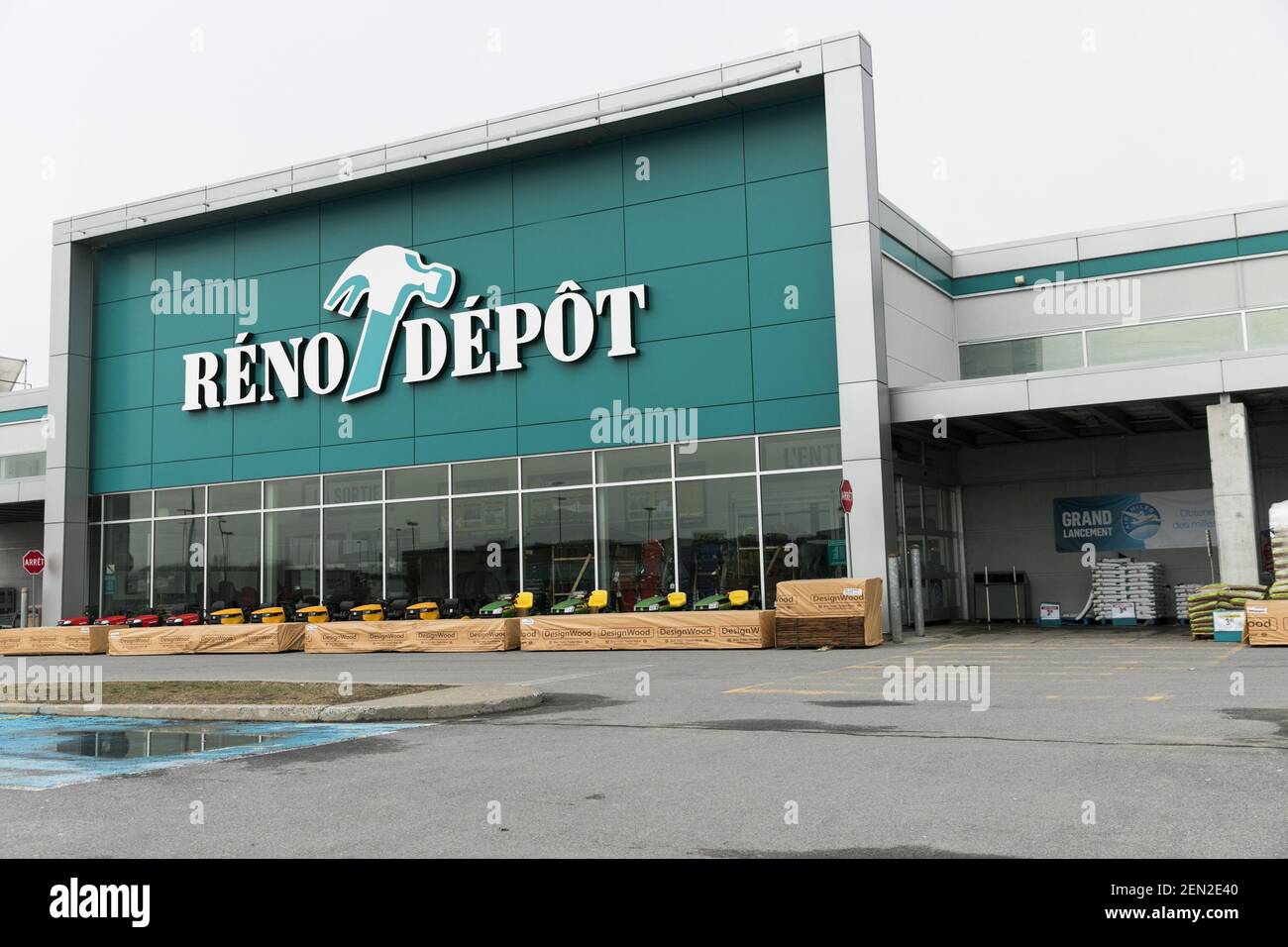 A logo sign outside of a RenoDepot retail store location in Vaudreuil