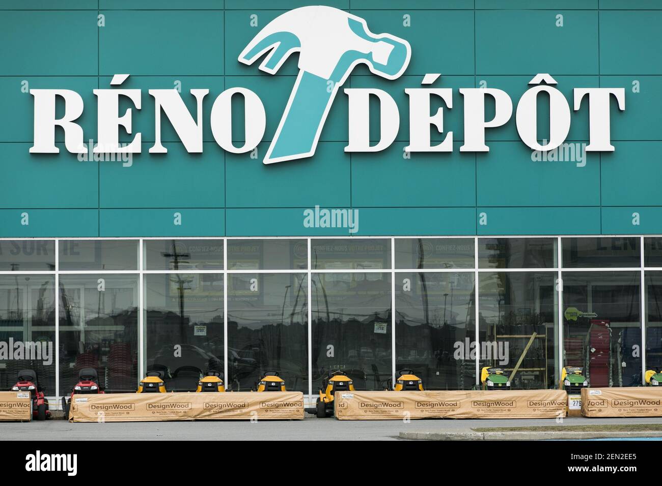 A logo sign outside of a RenoDepot retail store location in Vaudreuil