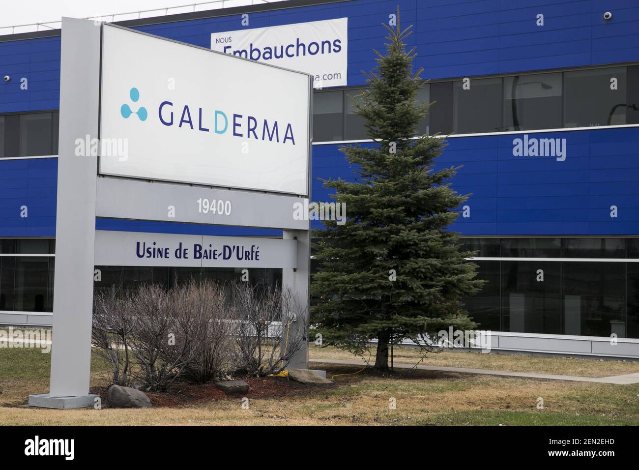 A logo sign outside of a facility occupied by Galderma in Baied’Urfé