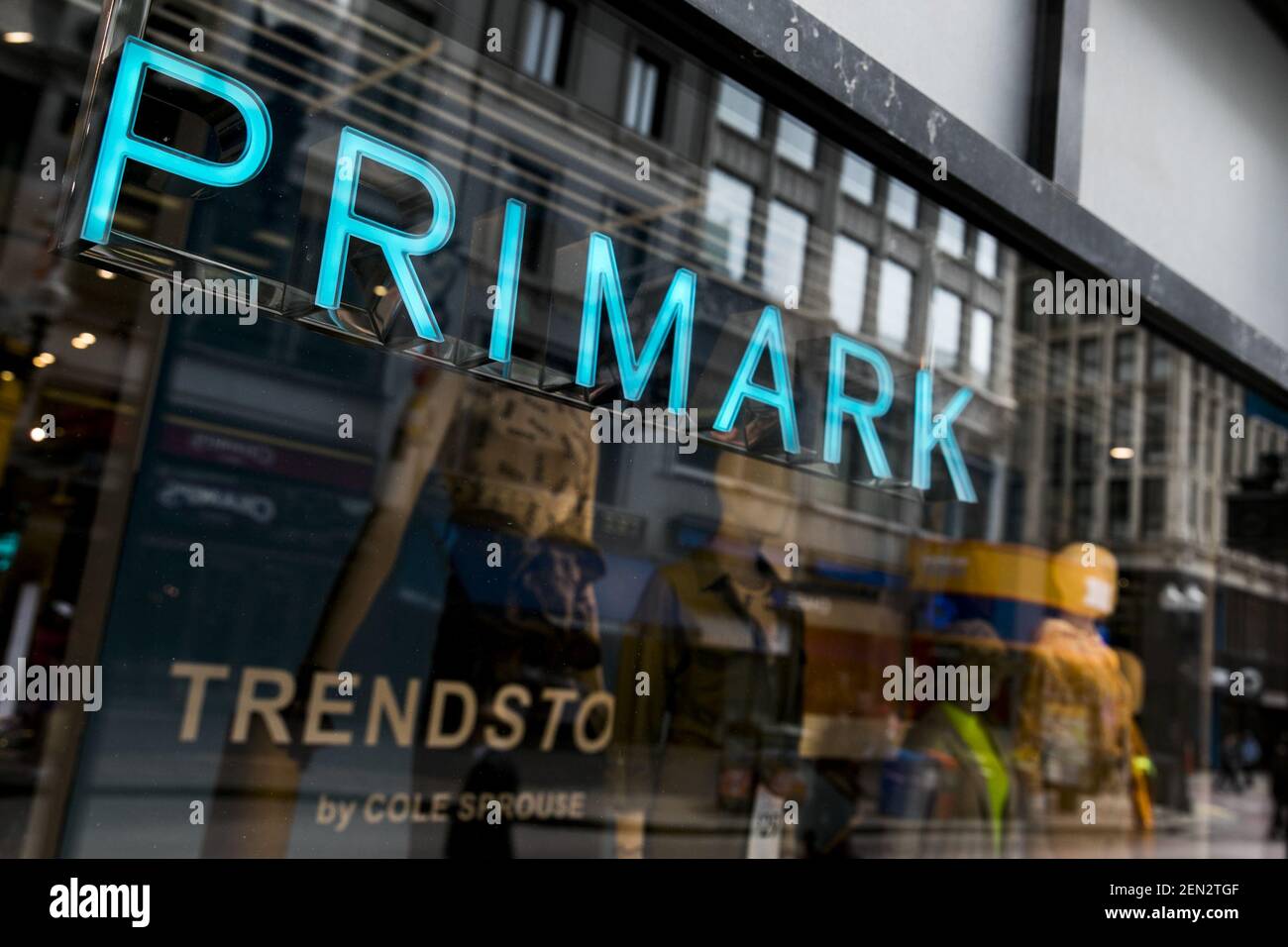 A logo sign outside of a Primark retail store location in Boston