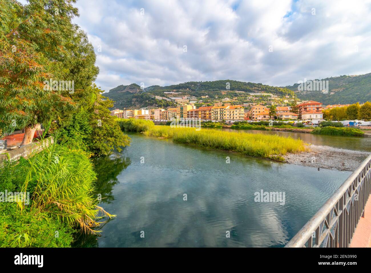 View from the bridge across the river Roya of the village of Ventimiglia, Italy, and inland to the mountains Stock Photo