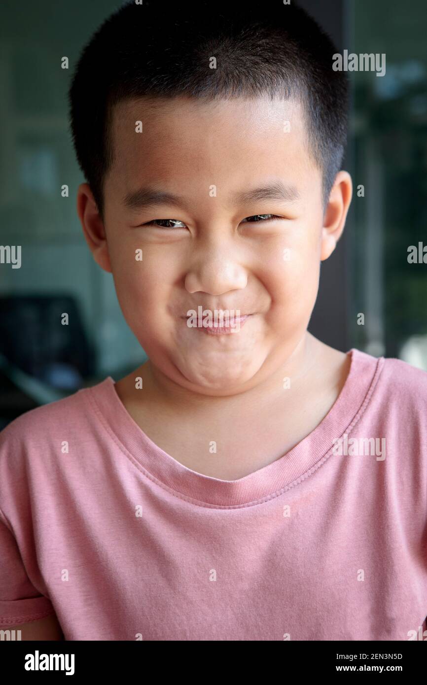 headshot funny face of asian children at home living room Stock Photo