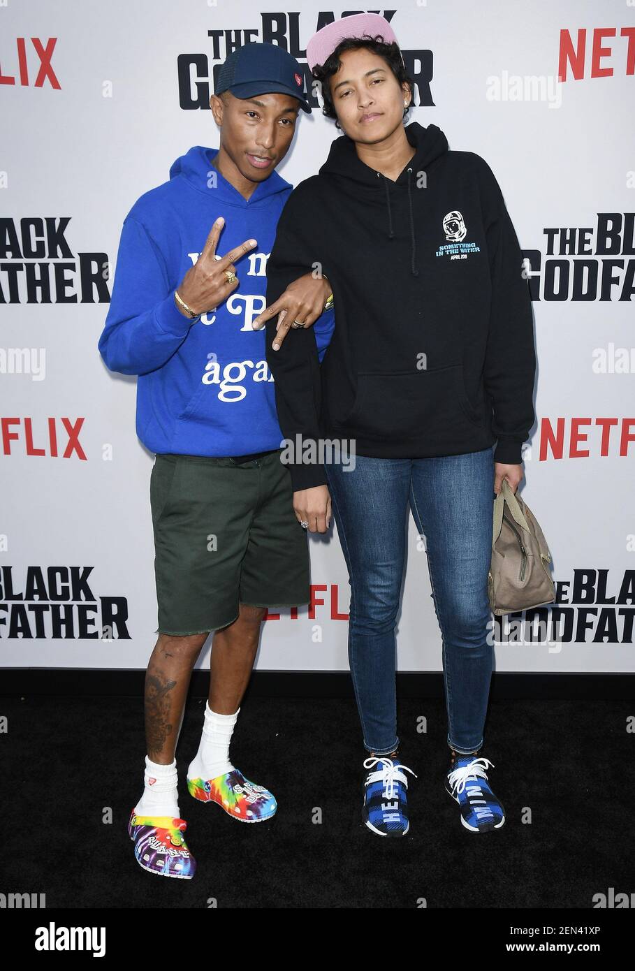 Pharrell Williams and his wife Helen Lasichanh attend the NBA