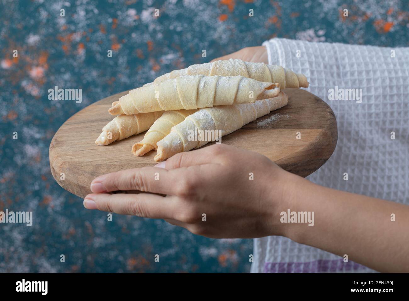 Holding mutaki cookies on a wooden board in the hand Stock Photo