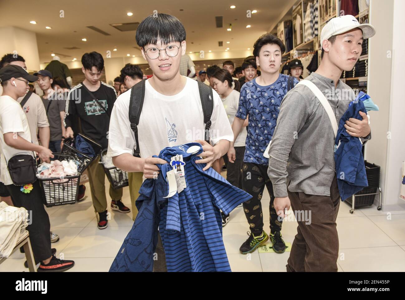 Chinese customers queue up in front of a Uniqlo store to buy the special  KAWS x Uniqlo UT collaborative capsule in Jinhua city, east China's  Zhejiang province, 3 June 2019. The special