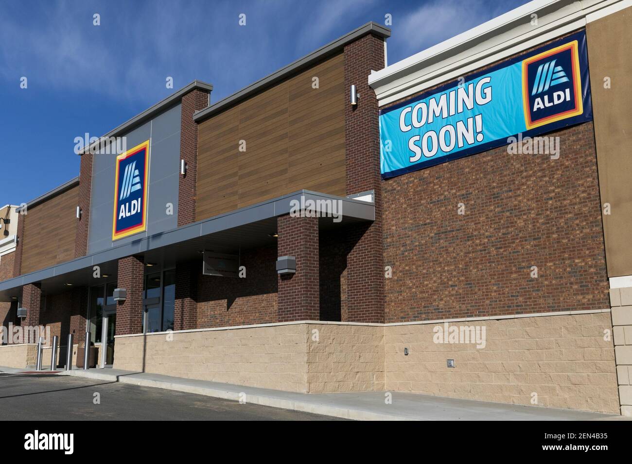 A logo sign outside of a Aldi retail grocery store location with a