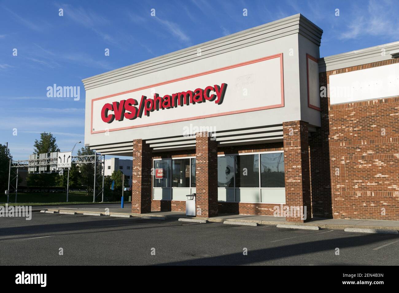 A logo sign outside of a CVS Pharmacy retail store location in