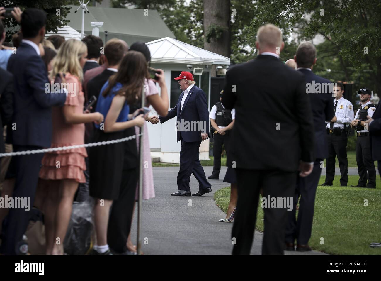 President Donald Trump and first lady Melania Trump greet people on the ...