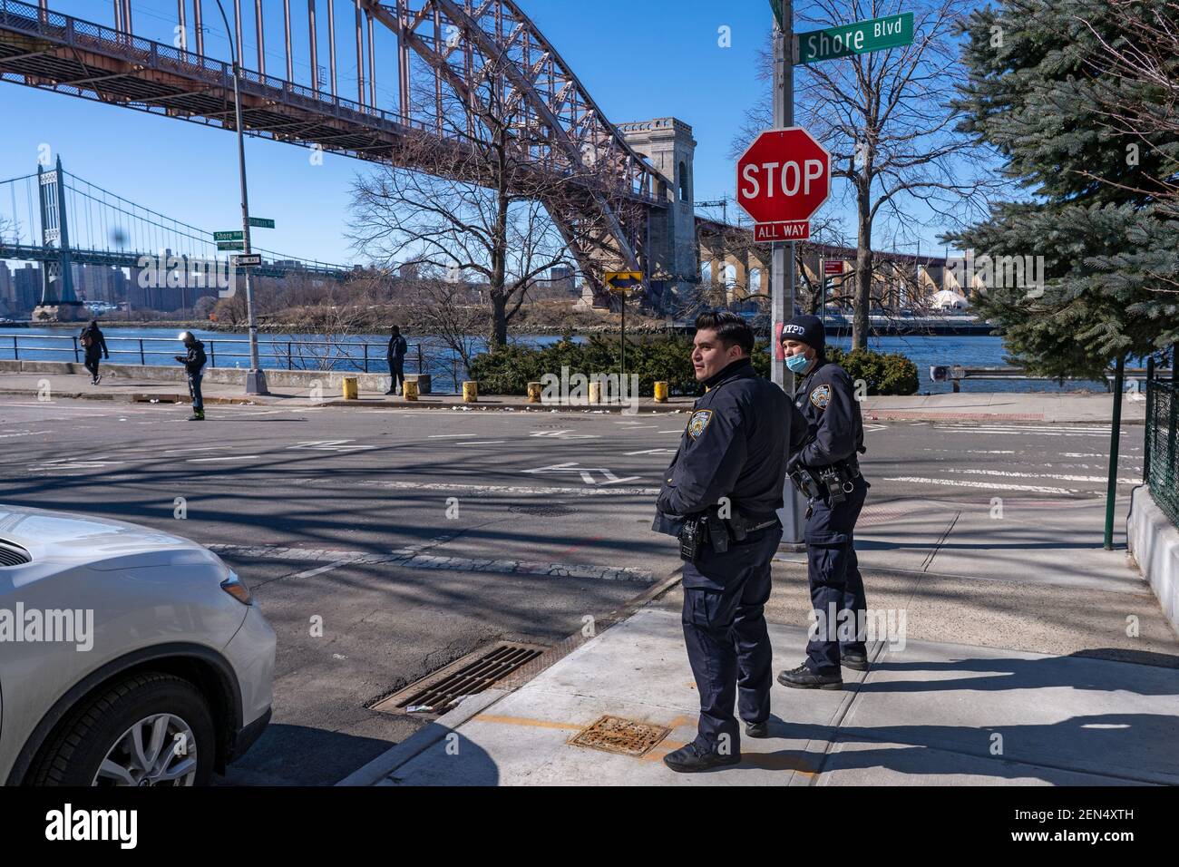 NEW YORK, NY – FEBRUARY 25: New York City Police Department (NYPD) officers from the 108 and 114 precinct watch the filming of the television show 'Blue Bloods' season eleven in Astoria Park on February 25, 2021 in New York City. Credit: Ron Adar/Alamy Live News Stock Photo