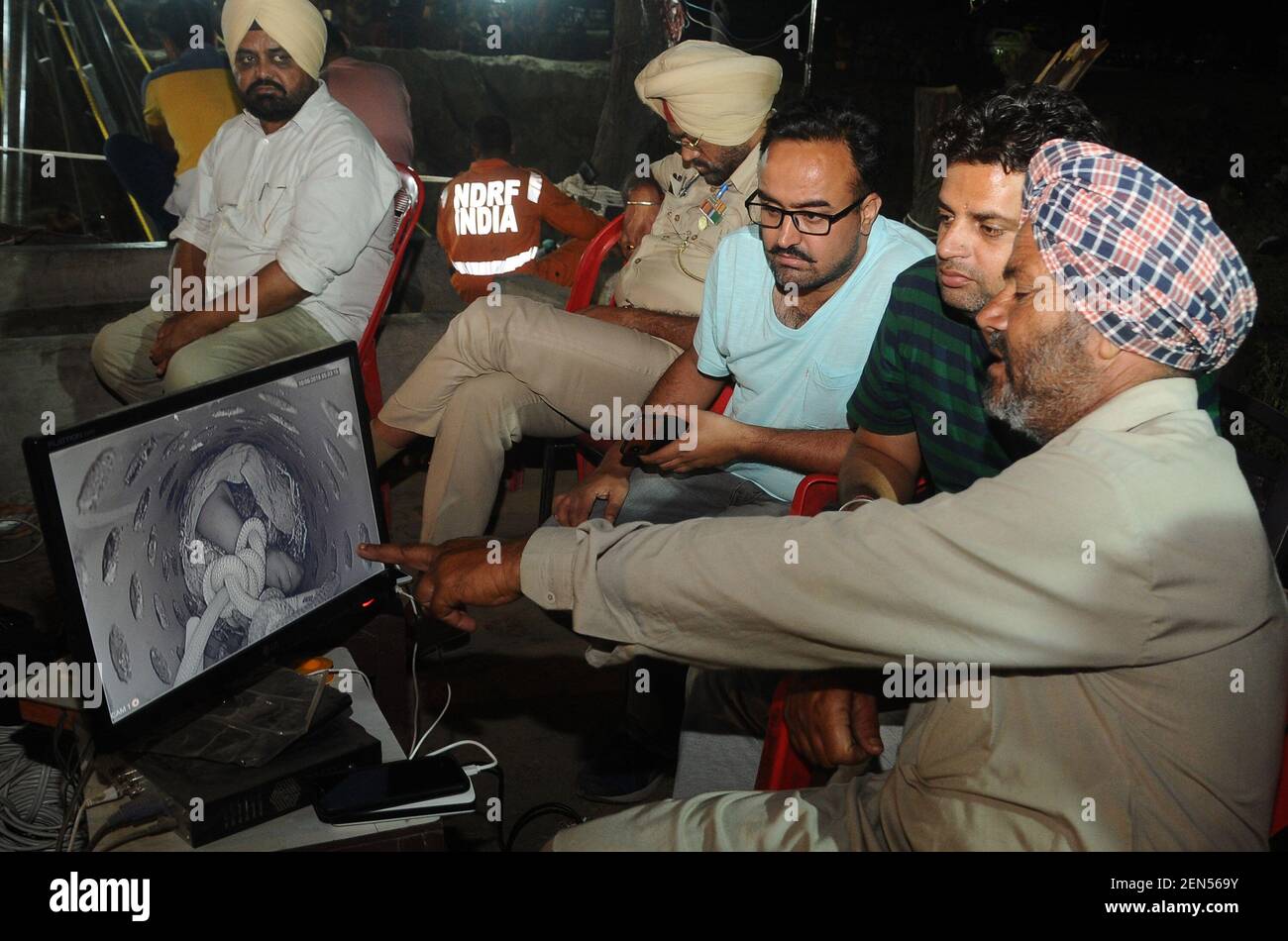 SANGRUR, INDIA - JUNE 10: Fatehveer Singh's grandfather Rohi Singh watches the live footage of his grandson's rescue operation on a screen early in the morning at 2:15 am, at Bhagwanpur village, on June 10, 2019 in Sangrur, India. Fatehvir Singh, a two-year-old boy remained stuck in a 150-foot-deep borewell in Punjab's Sangrur district, amid mounting anger over the delay in retrieving him even after over 100 hours since he fell into it. He fell into fell into the unused seven-inch wide borewell in a field around 4 pm on Thursday.(Photo by Bharat Bhushan/Hindustan Times/Sipa USA) Stock Photo