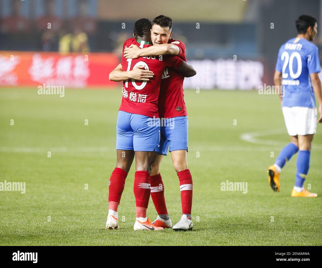 Cameroonian football player Christian Bassogog of Henan Jianye F.C. celebrates with Zhou Dingyang after scoring against Jiangsu Suning F.C. in their 7th round match during the 2019 Chinese Football Association Super League (CSL) in Zhengzhou city, central China's Henan province, 27 April 2019. Henan Jianye defeated Jiangsu Suning 2-1. Stock Photo